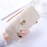 The long hand in the lady's purse holds the bag of the zipper key card