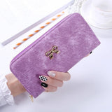 The long hand in the lady's purse holds the bag of the zipper key card