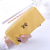 The long hand in the lady's purse holds the bag of the zipper key card